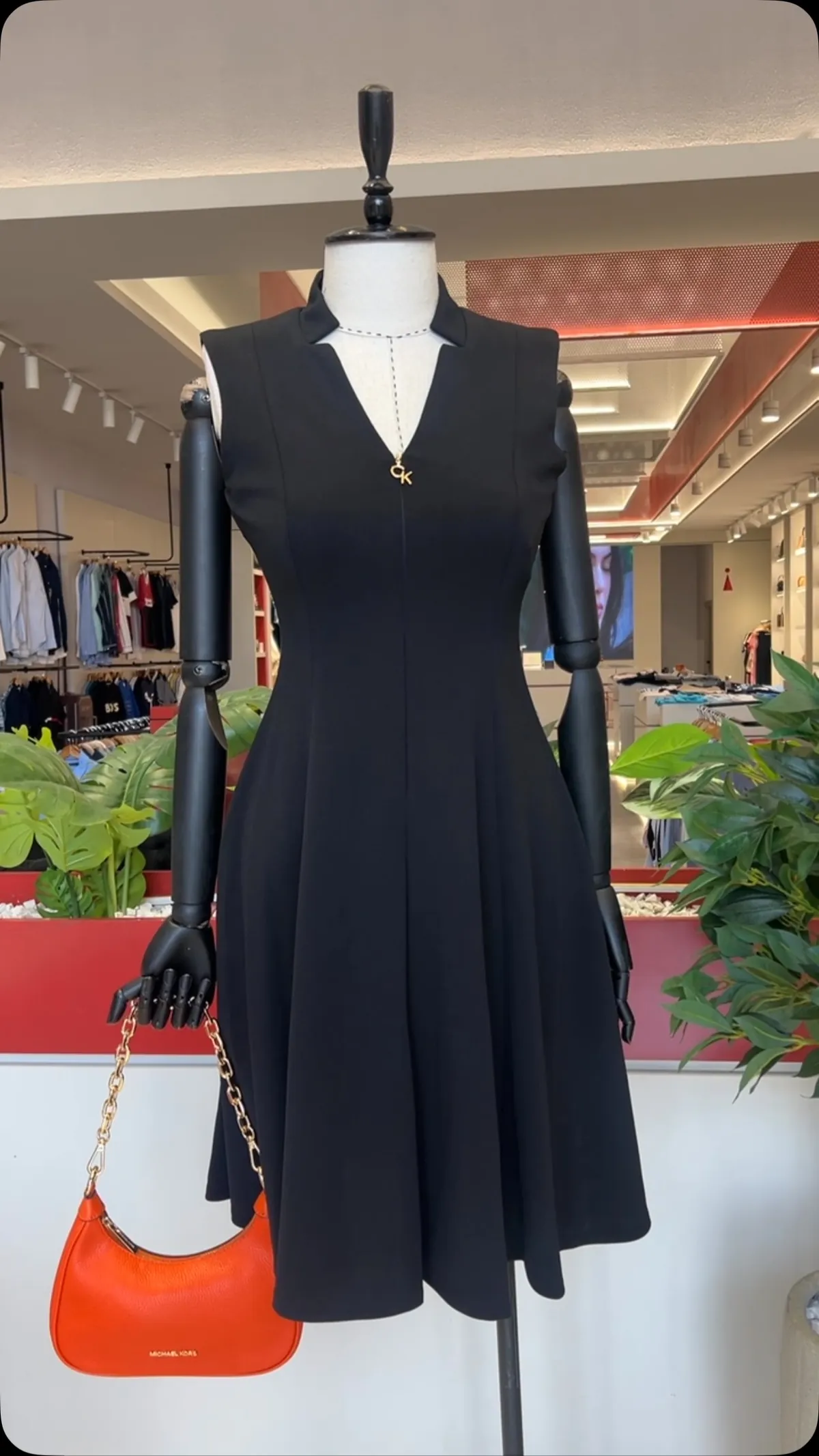 Black Sleeveless Dress and Orange Handbag